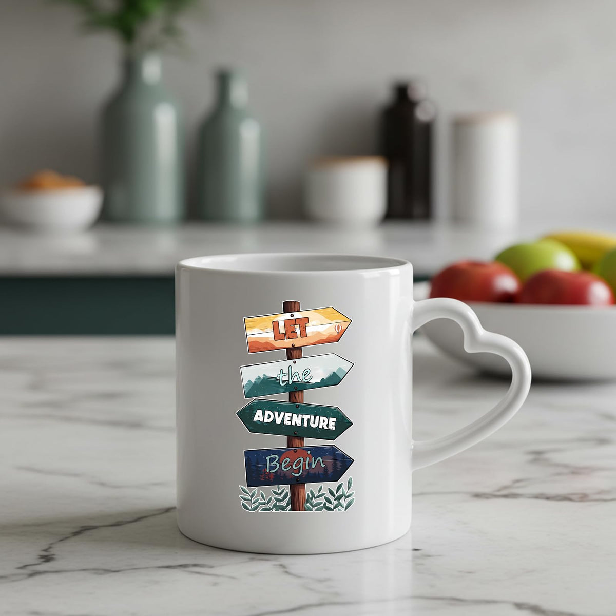 Let the Adventure Begin heart-handle mug on a marble counter with fruit