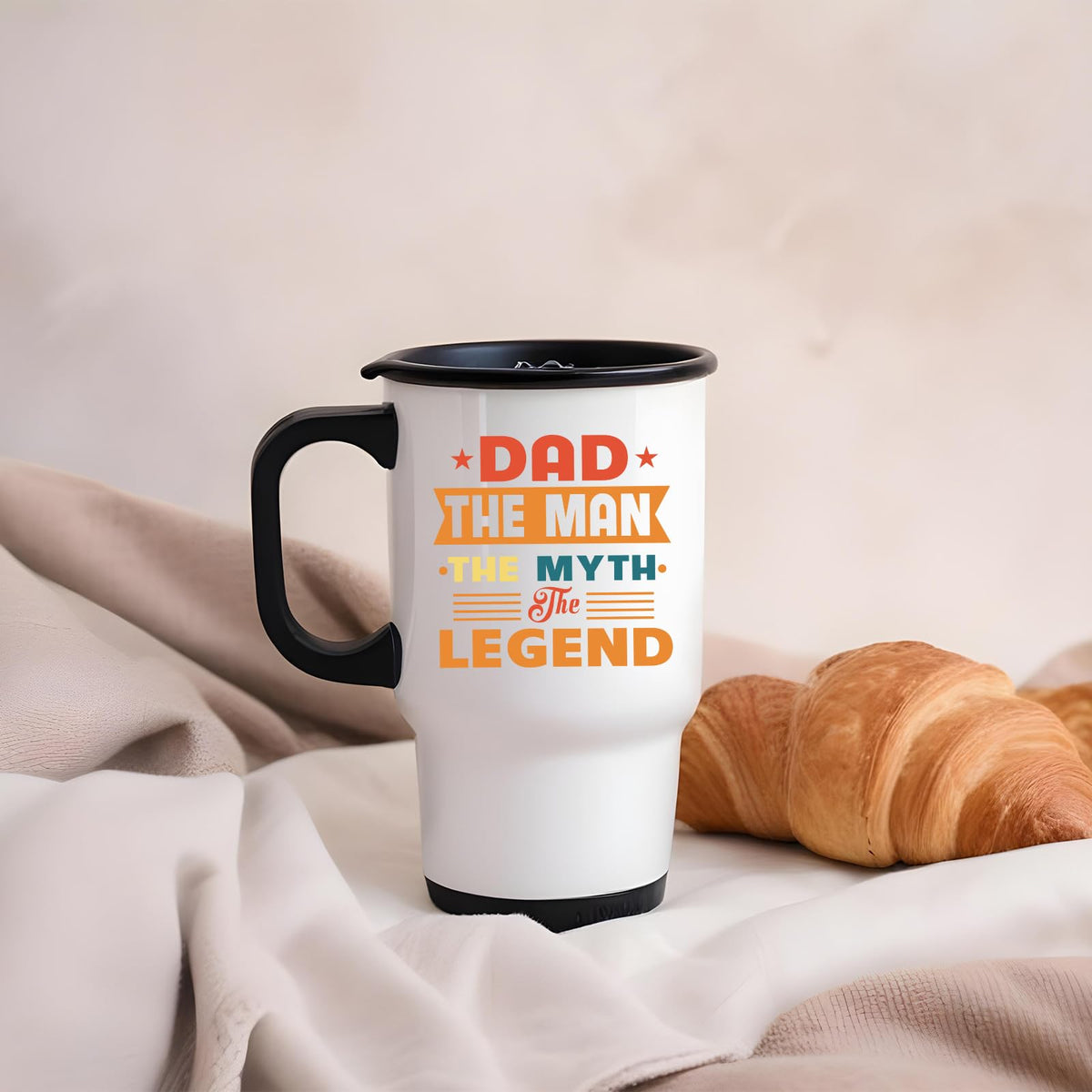 Dad the Man retro travel mug on a soft blanket beside a croissant