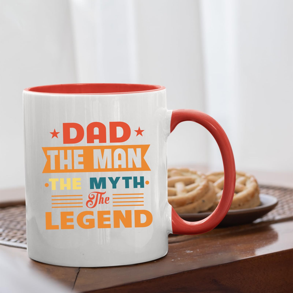 Dad the Man retro mug with a red handle beside biscuits