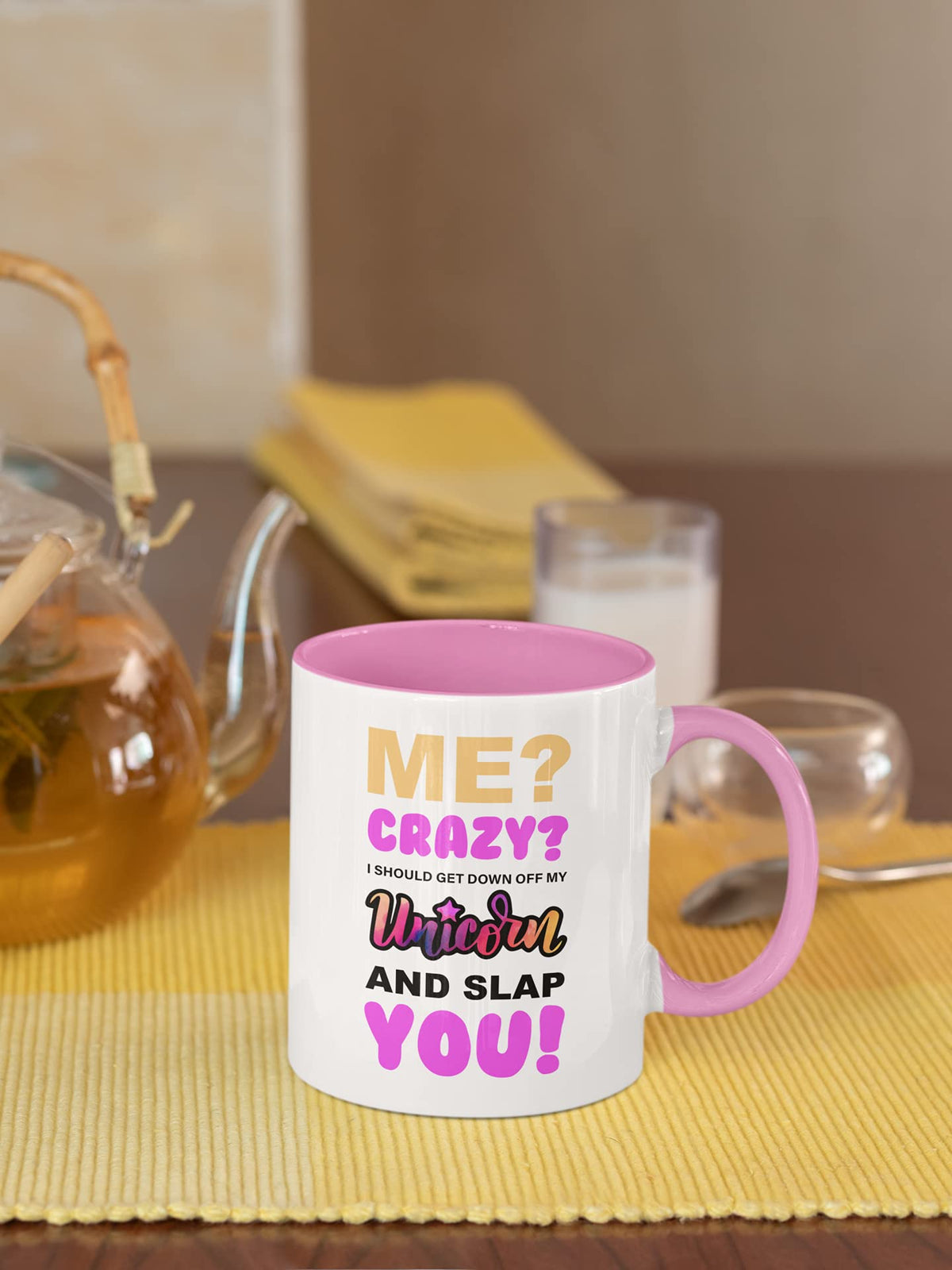 Unicorn slogan mug next to a teapot