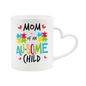 White heart-handle mug with “Mom of an AU-SOME child” with colourful puzzle pieces and hearts