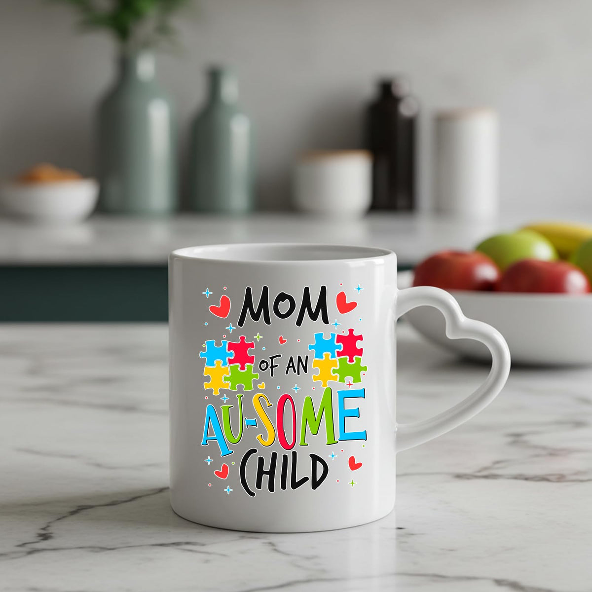 Mom of an Au-Some Child heart-handle mug on a marble counter with fruit