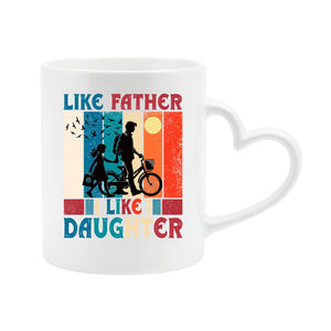 White heart-handle mug with a dad and daughter with a bike in silhouette over retro stripes and “Like father, like daughter”
