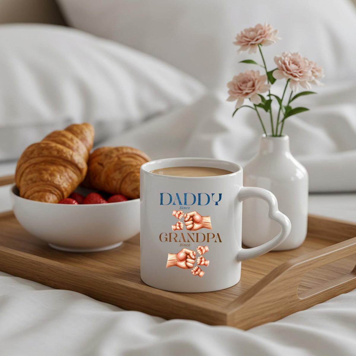 Daddy and Grandpa fist bump heart-handle mug on a breakfast tray with croissants and flowers