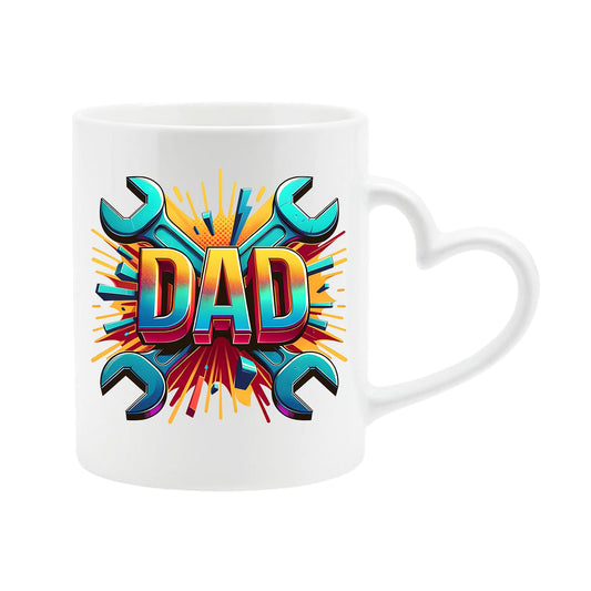 White heart-handle mug with a comic-style “DAD” on a burst of crossed spanners
