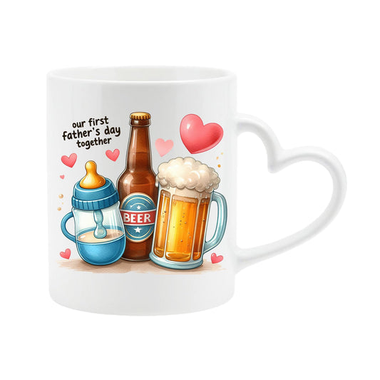 White heart-handle mug with a baby bottle, a beer bottle and a frothy pint with hearts and “Our first Father’s Day together”