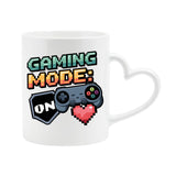 White heart-handle mug with “Gaming Mode: On” with a game controller and pixel heart
