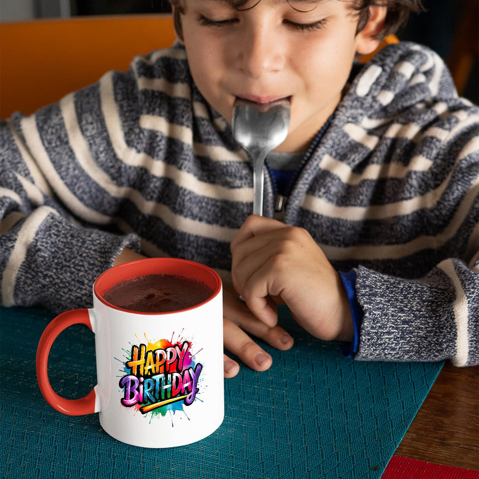Child drinking from the mug with a red handle