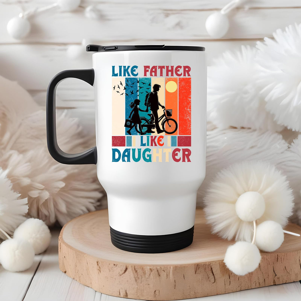 Like Father Like Daughter travel mug on a wooden slice with white pom-poms