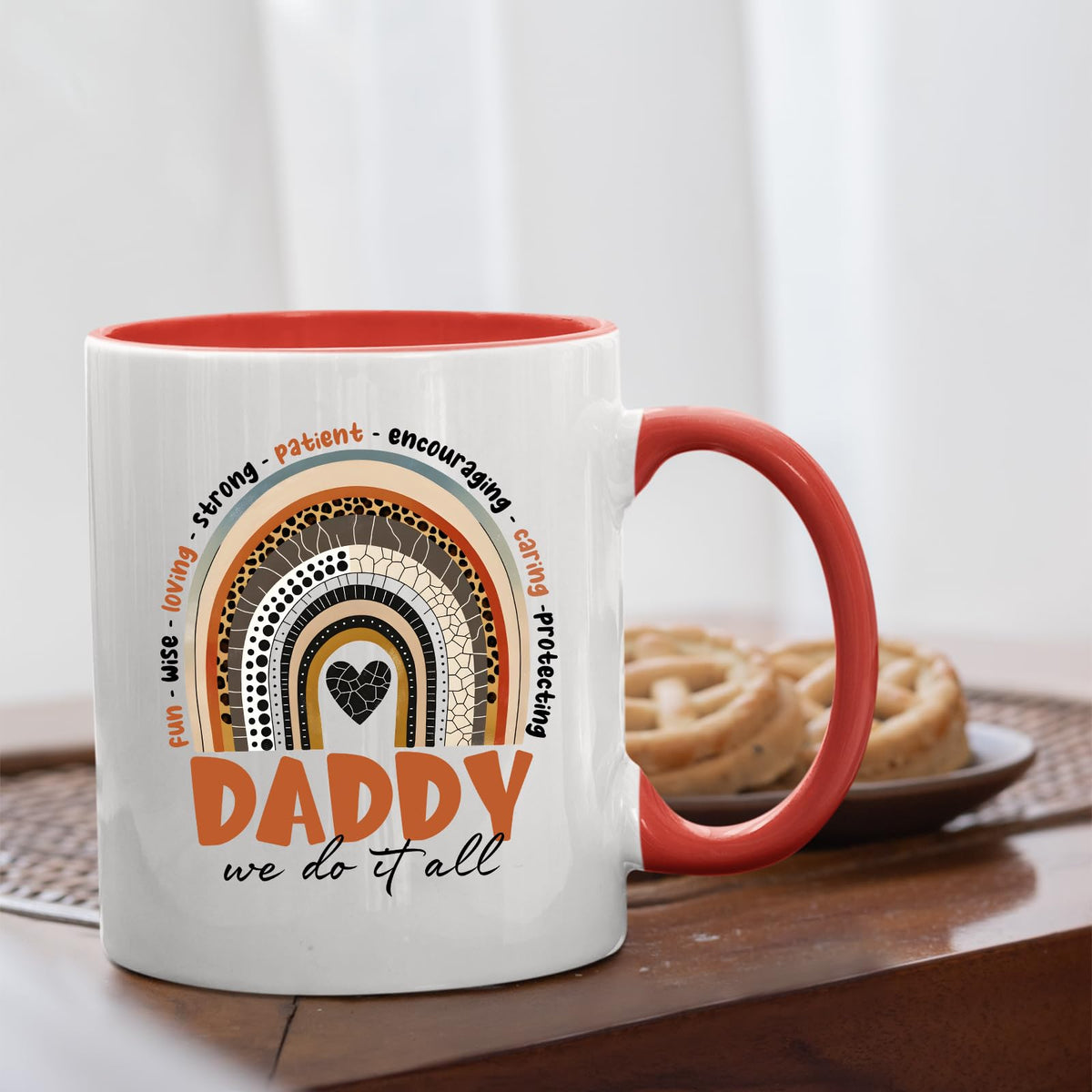 Daddy boho rainbow mug with a red handle beside biscuits