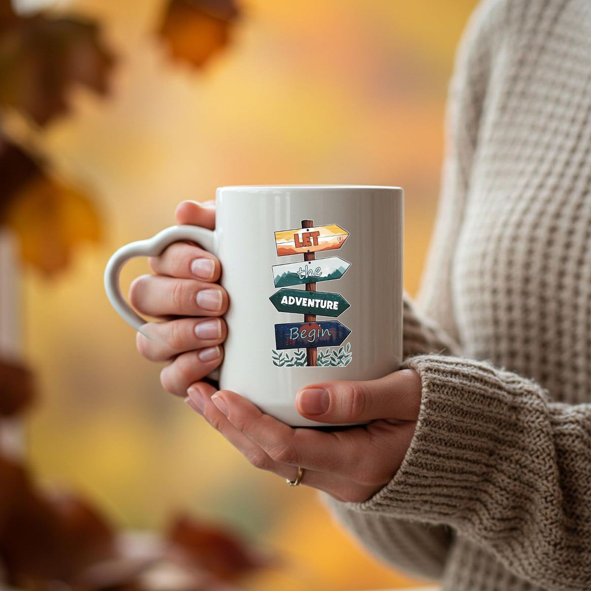 Hands holding the Let the Adventure Begin heart-handle mug