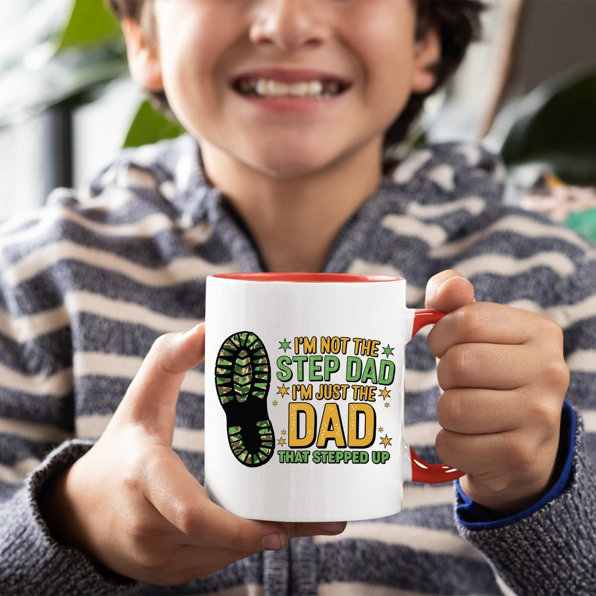 Smiling child holding the Dad That Stepped Up mug with a red handle