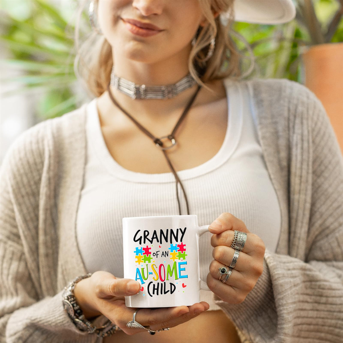 Woman in a cardigan holding the Granny of an Au-Some Child mug