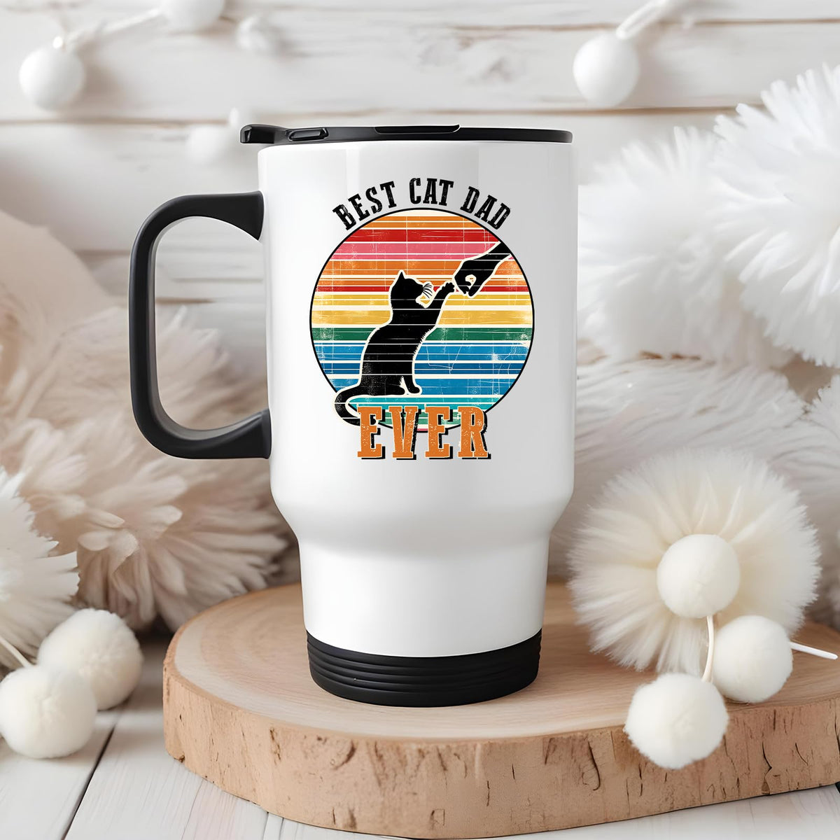 Best Cat Dad Ever travel mug on a wooden slice with white pom-poms