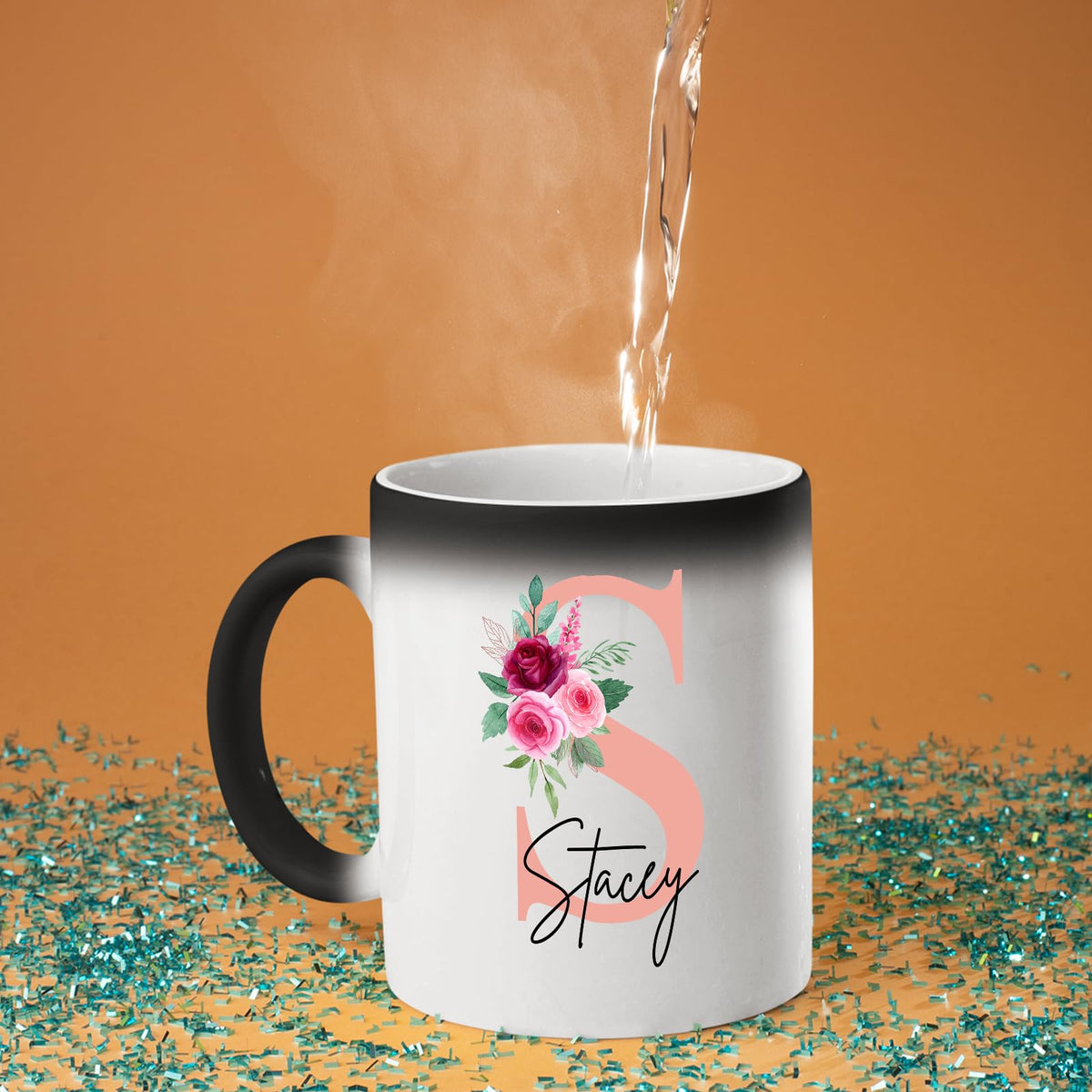 Hot water poured into the colour changing mug as a blush pink initial with roses and an example name appears