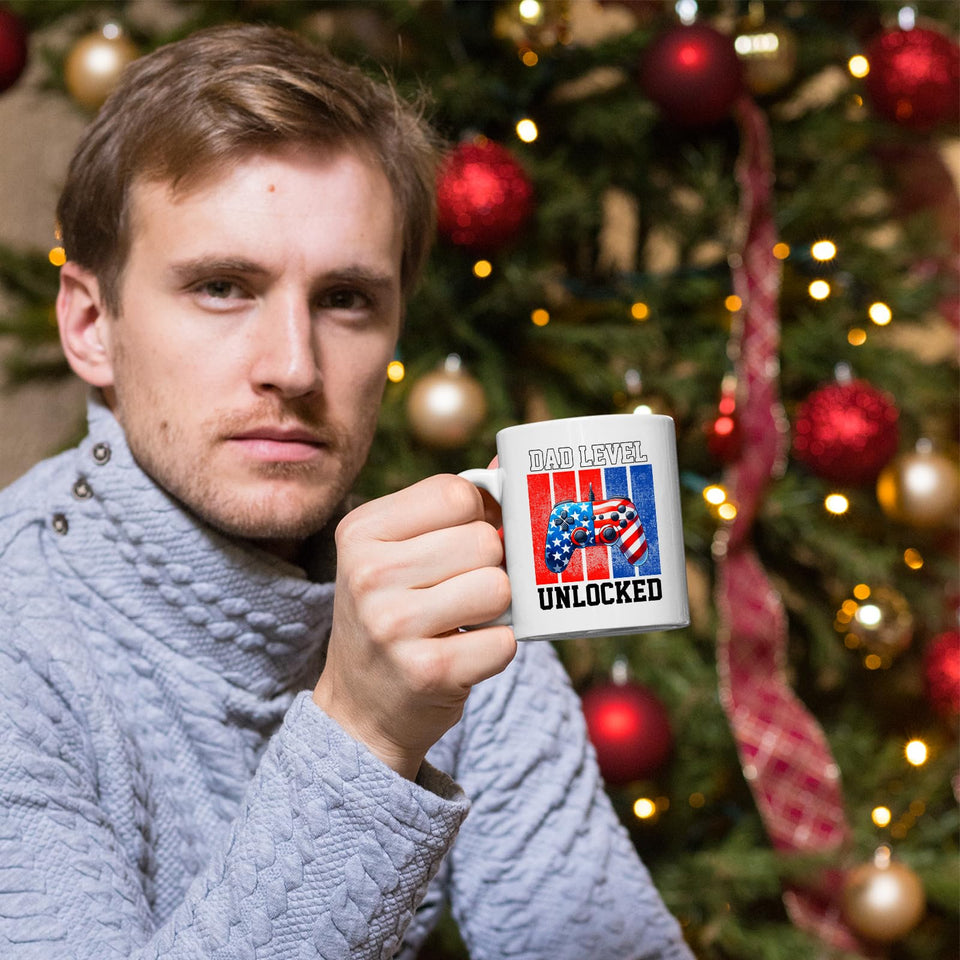 Man holding the Dad Level Unlocked mug in front of a Christmas tree