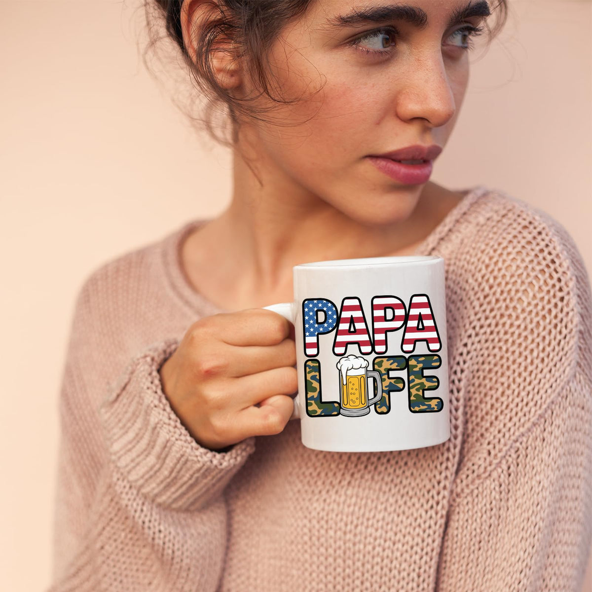 Woman in a pink jumper holding the Papa Life mug