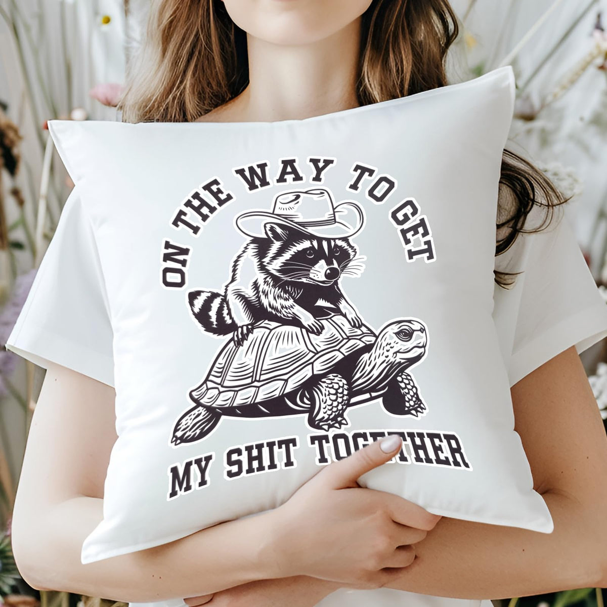 Woman hugging the raccoon and tortoise cushion