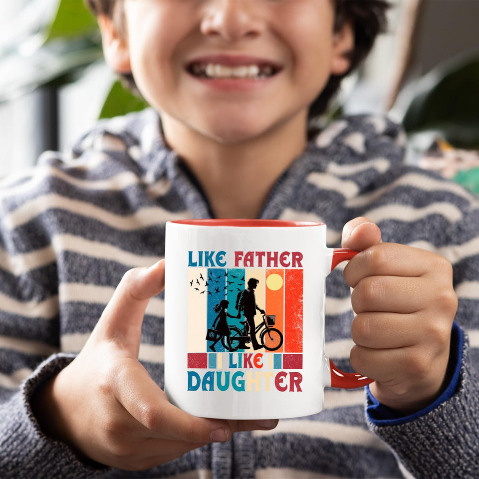 Smiling child holding the Like Father Like Daughter mug with a red handle