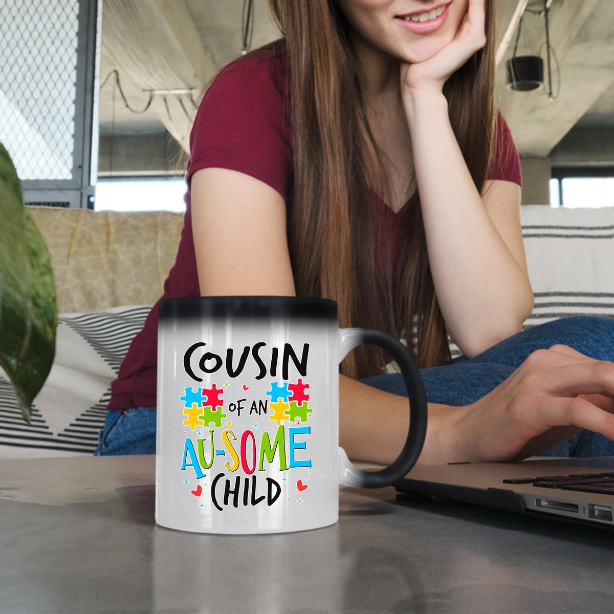 Woman at a laptop with the Cousin of an Au-Some Child colour changing mug