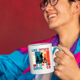 Smiling person in a colourful jacket holding the Like Father Like Daughter mug with a light green handle