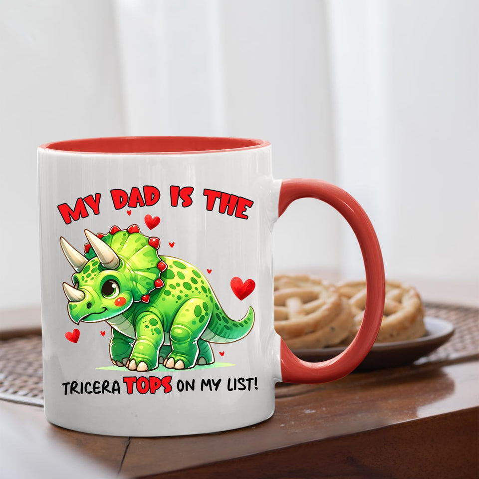 Triceratops dad mug with a red handle beside biscuits