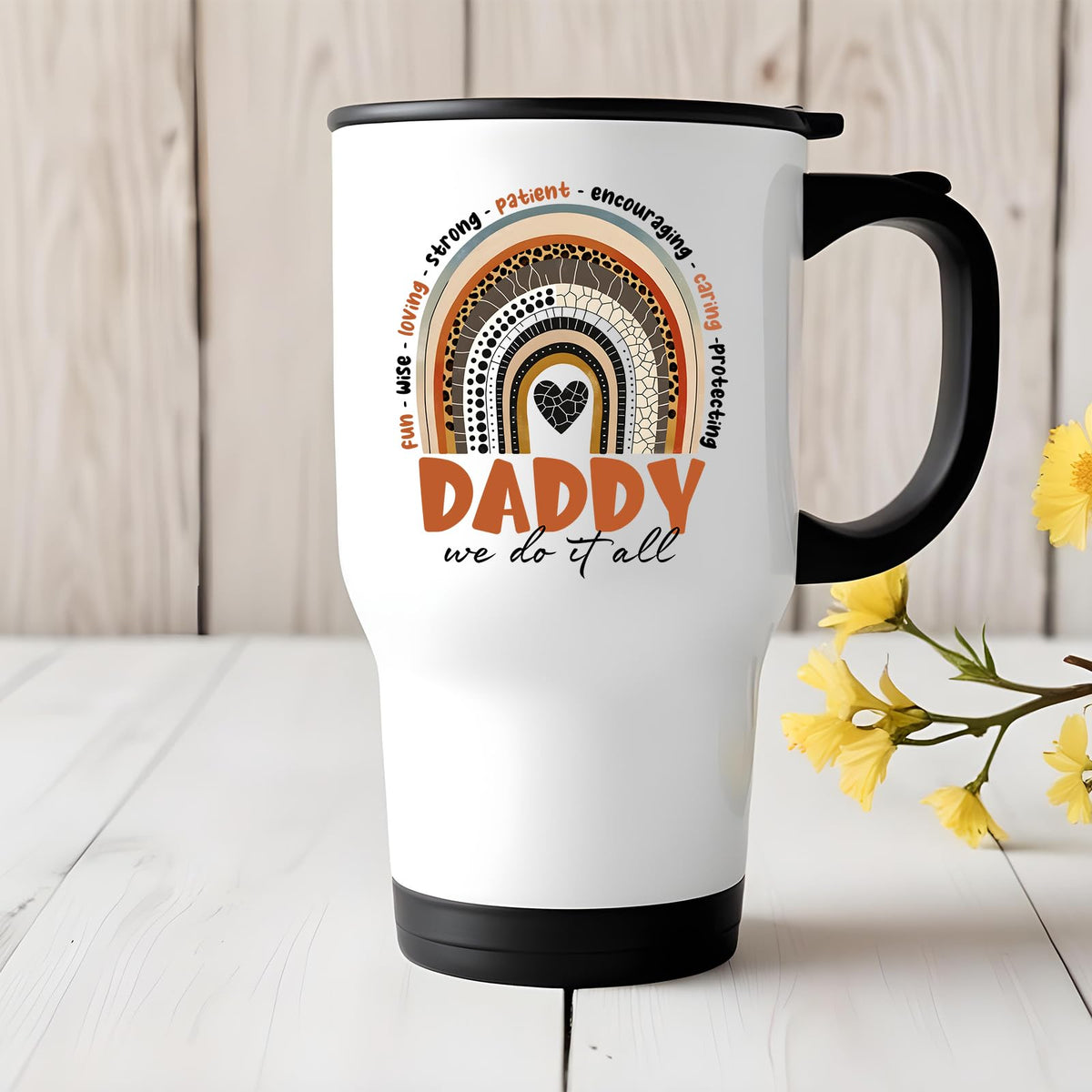 Daddy boho rainbow travel mug on a white wooden table with yellow flowers