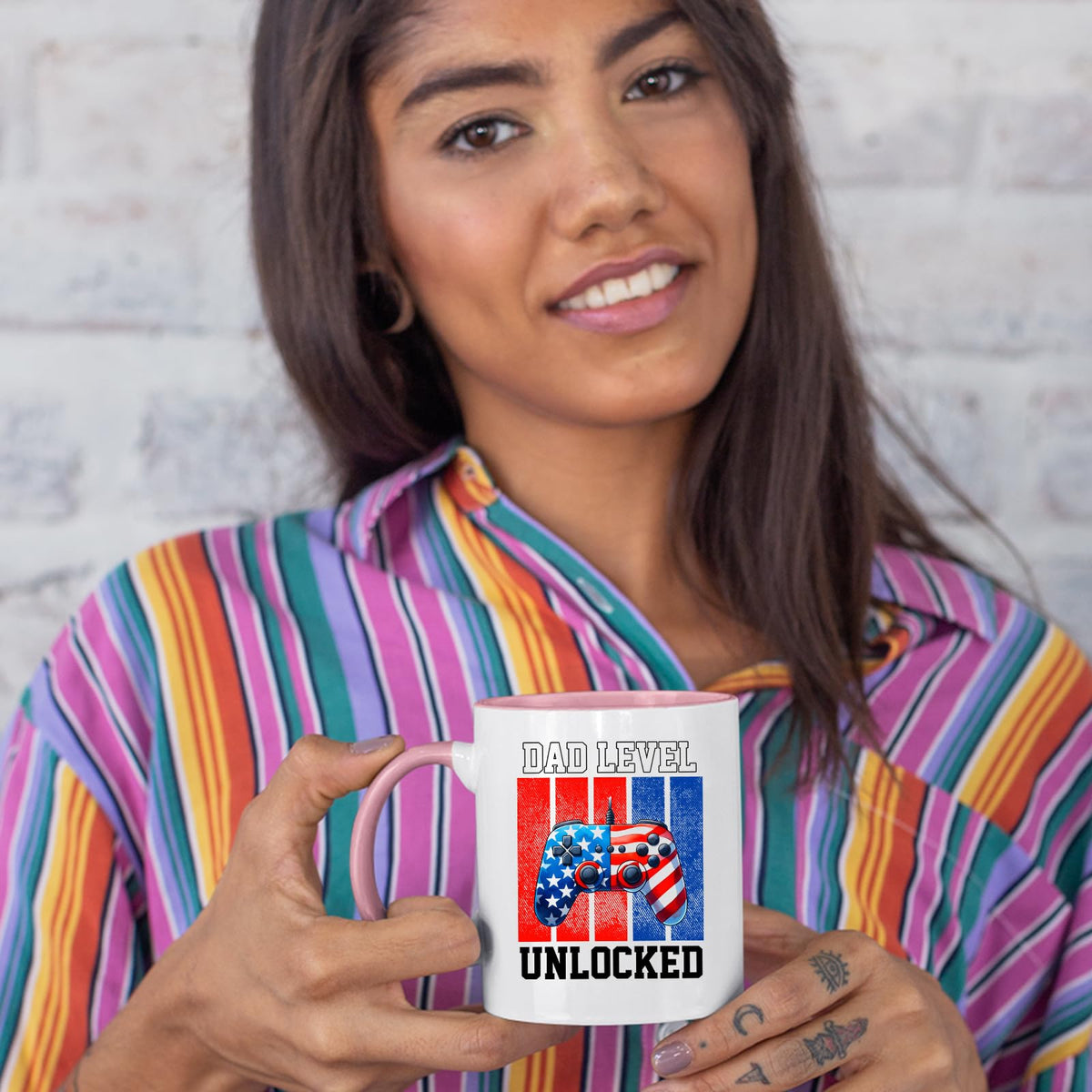 Woman in a striped shirt holding the Dad Level Unlocked colour handle mug