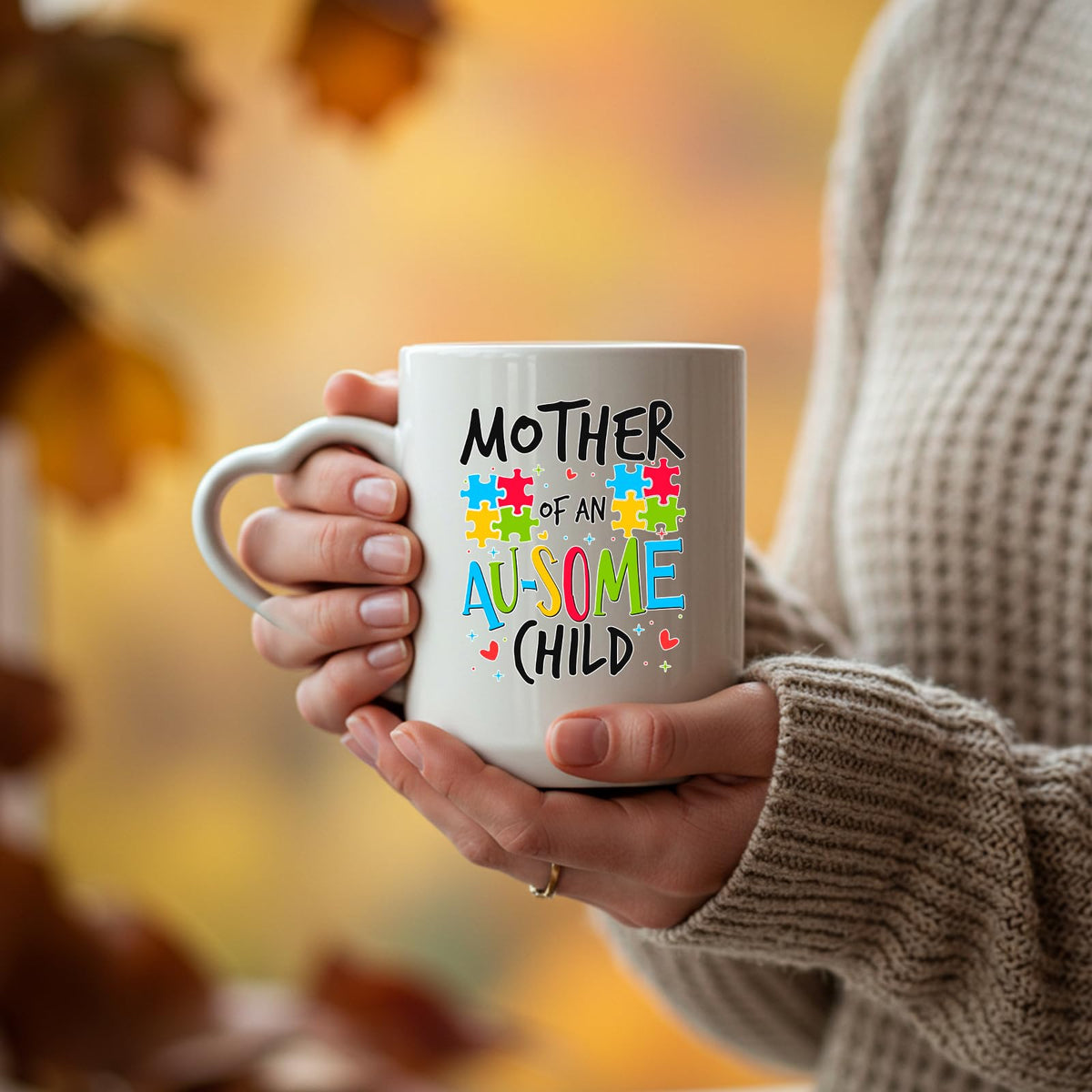 Hands holding the Mother of an Au-Some Child heart-handle mug