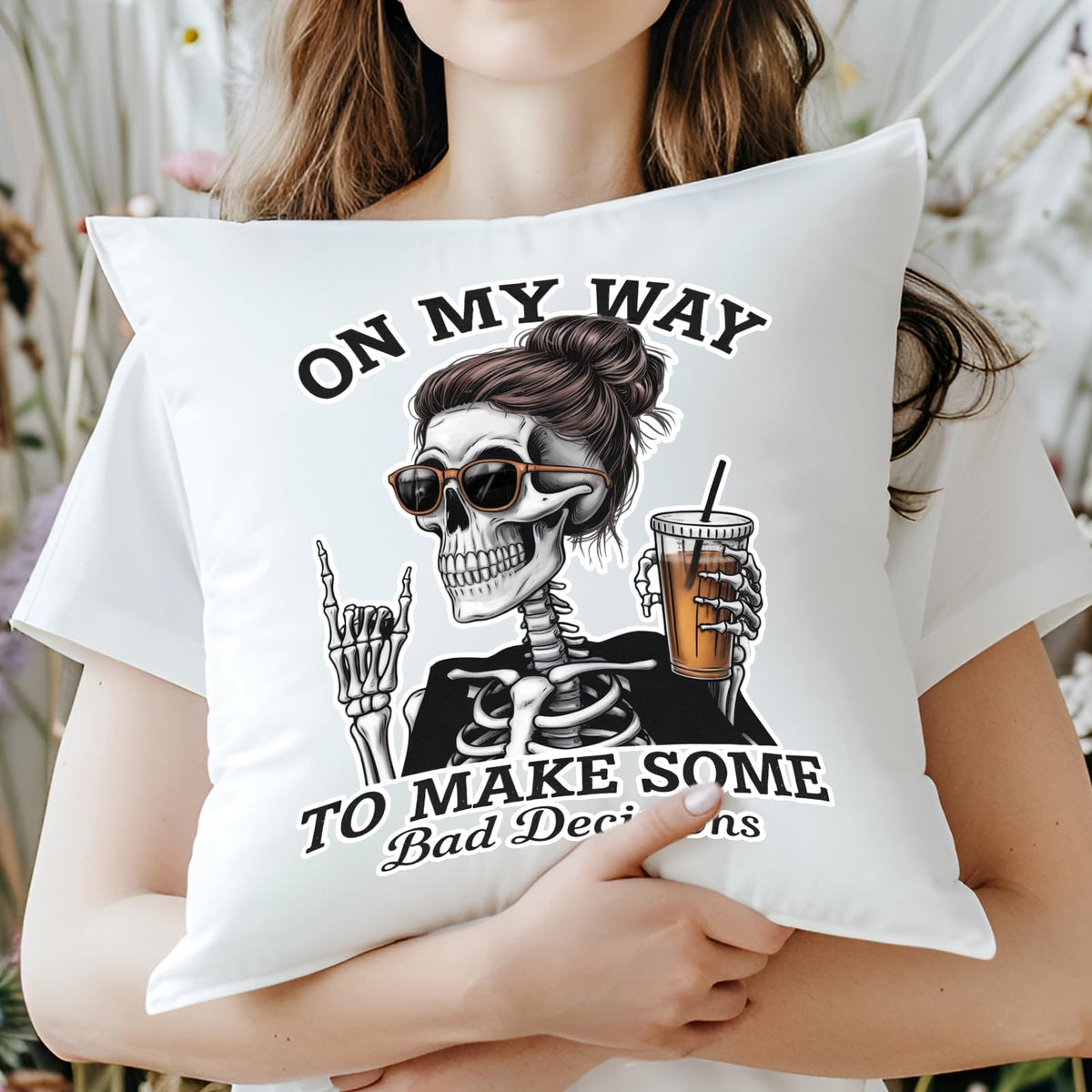 Woman hugging the Bad Decisions skeleton cushion