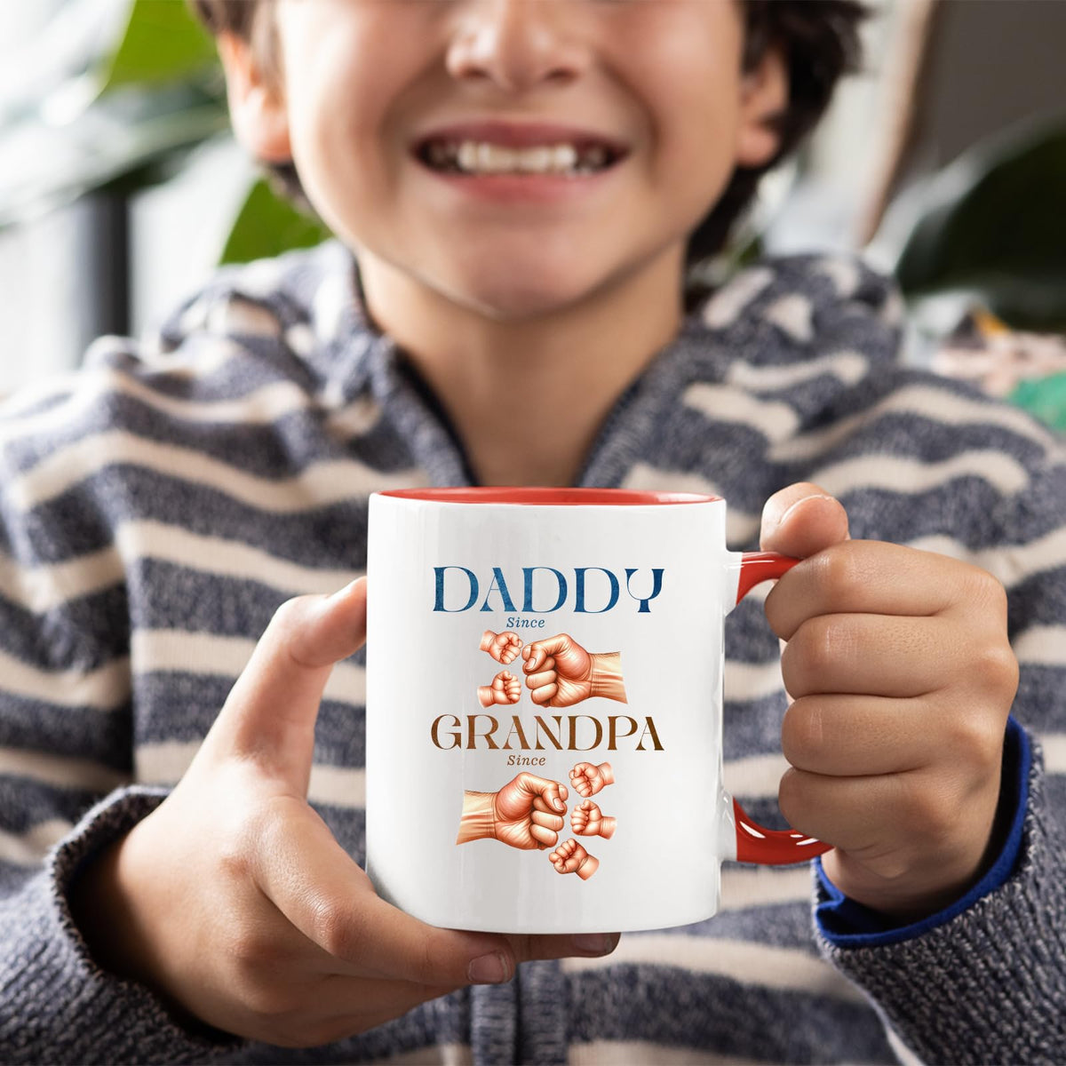 Smiling child holding the Daddy and Grandpa fist bump mug with a red handle