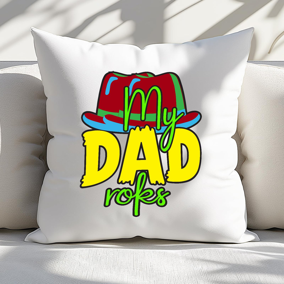 Cushion with the colourful My Dad Rocks hat design on a sofa