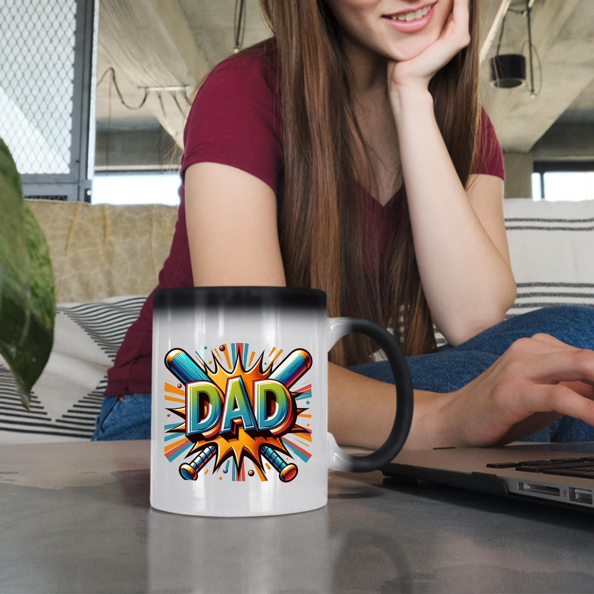 Woman at a laptop with the DAD baseball bats colour changing mug