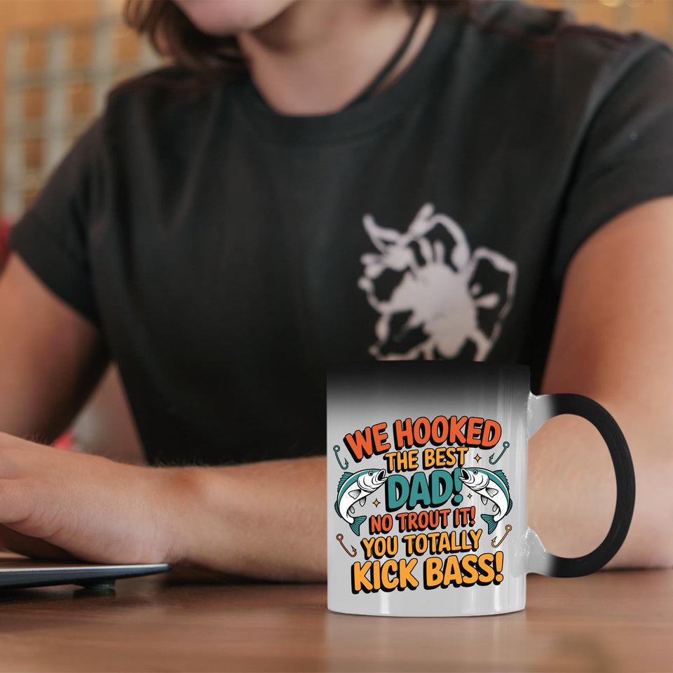 We Hooked the Best Dad colour changing mug on a desk beside a laptop
