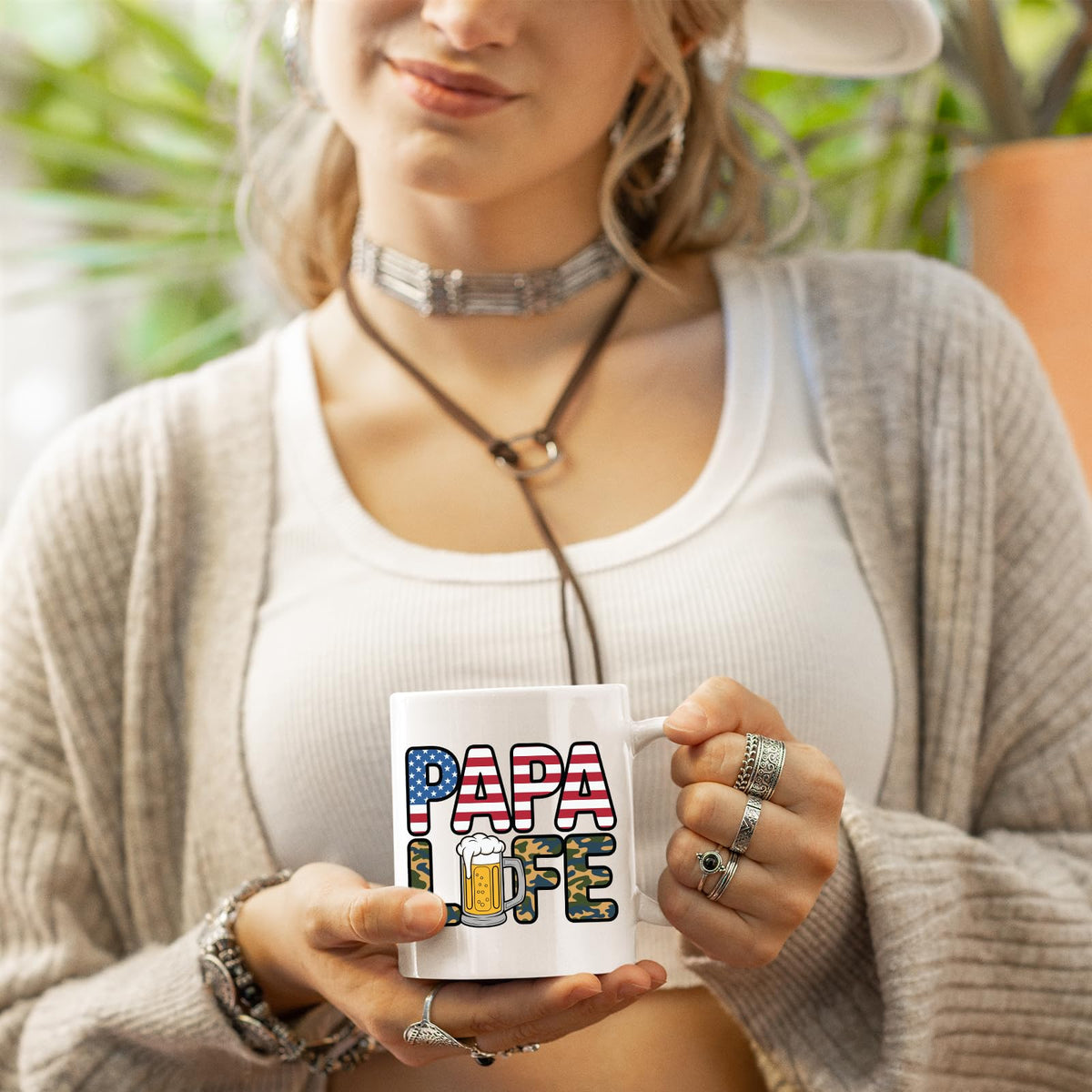 Woman in a cardigan holding the Papa Life mug