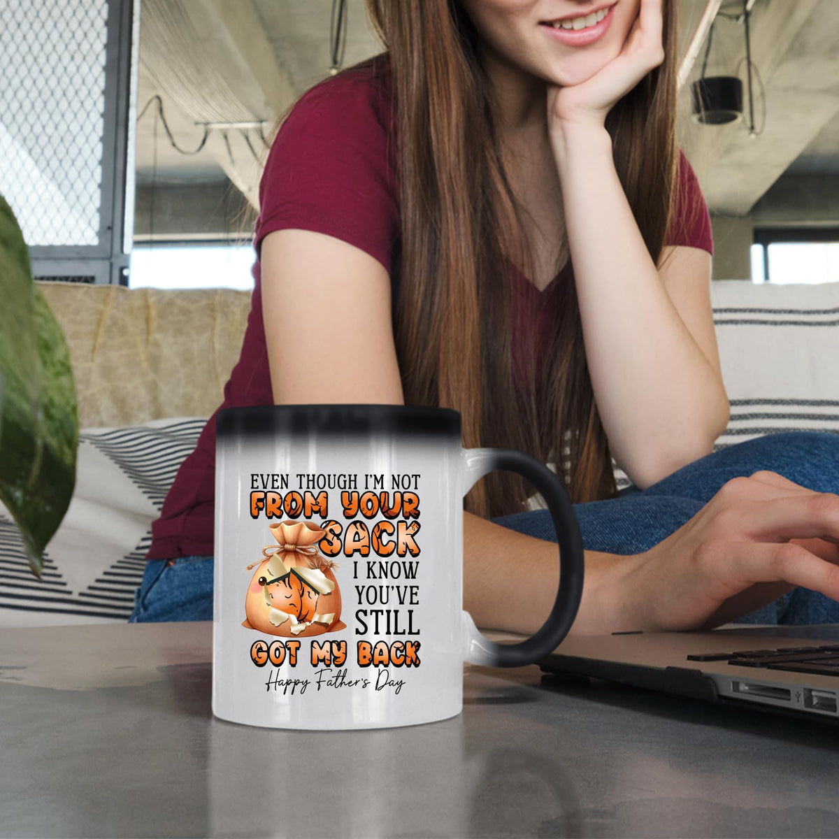 Woman at a laptop with the Not From Your Sack colour changing mug