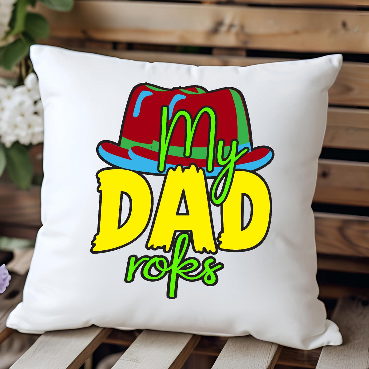 Cushion with the colourful My Dad Rocks hat design on a wooden bench