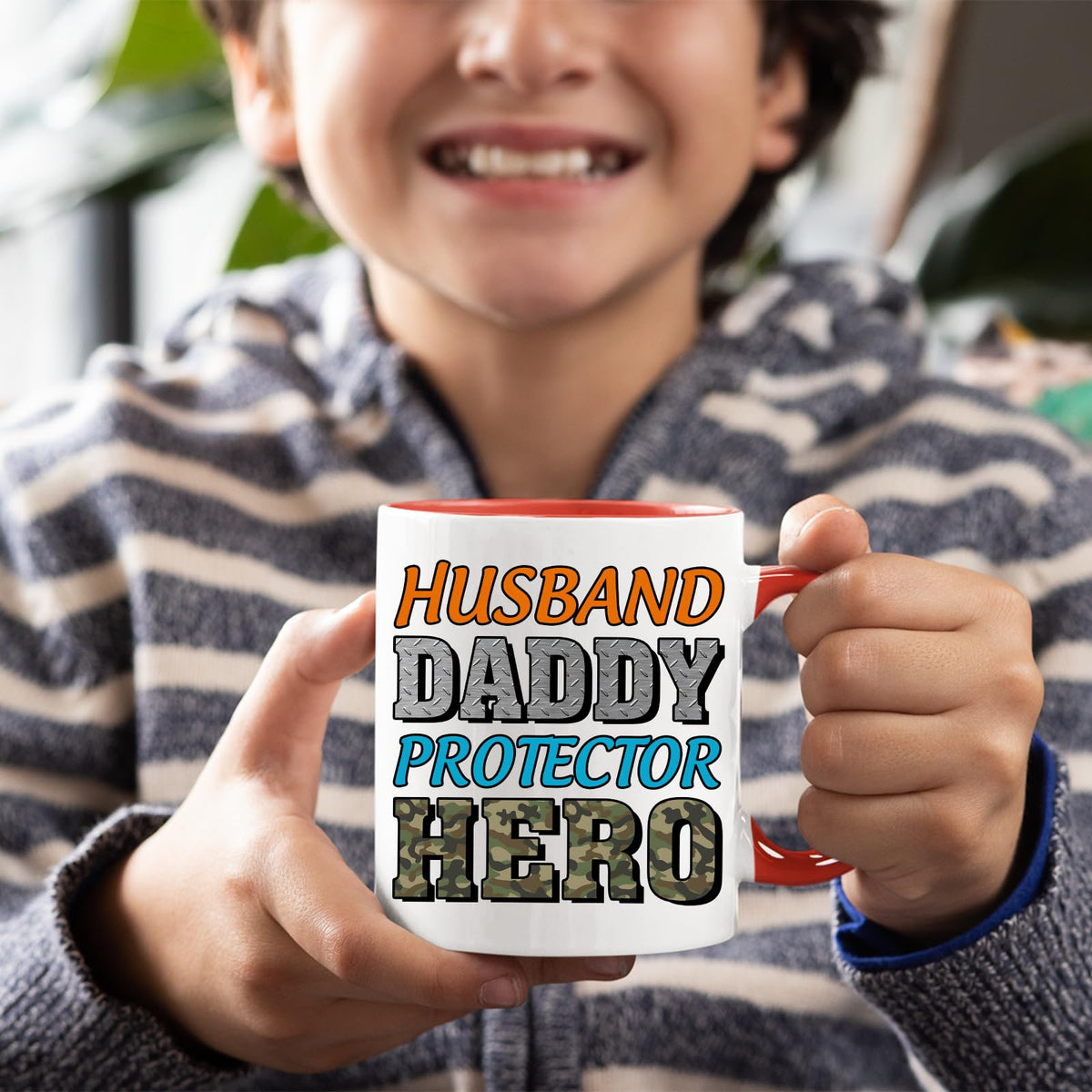 Smiling child holding the Husband Daddy Protector Hero camo mug with a red handle