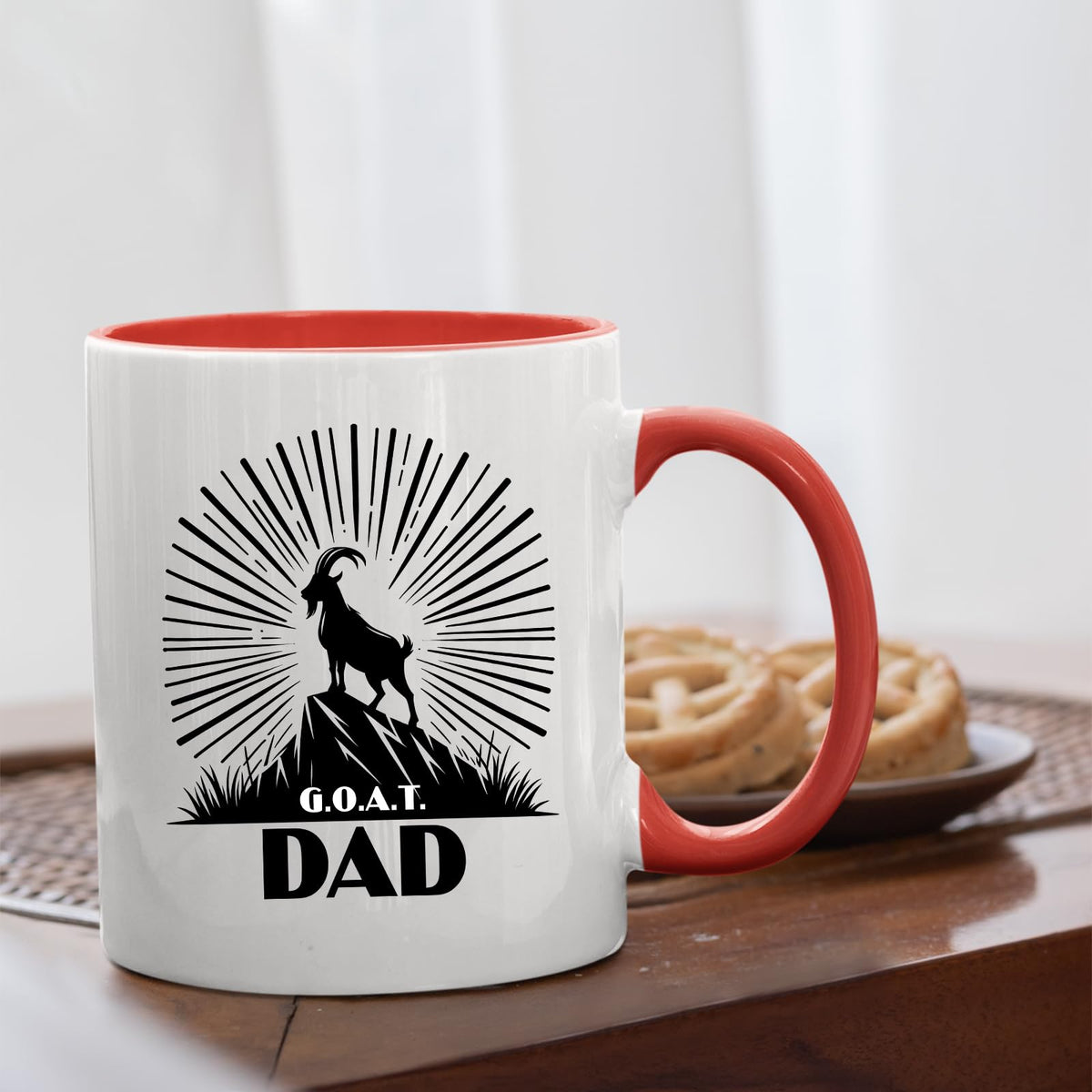 GOAT Dad mug with a red handle beside biscuits