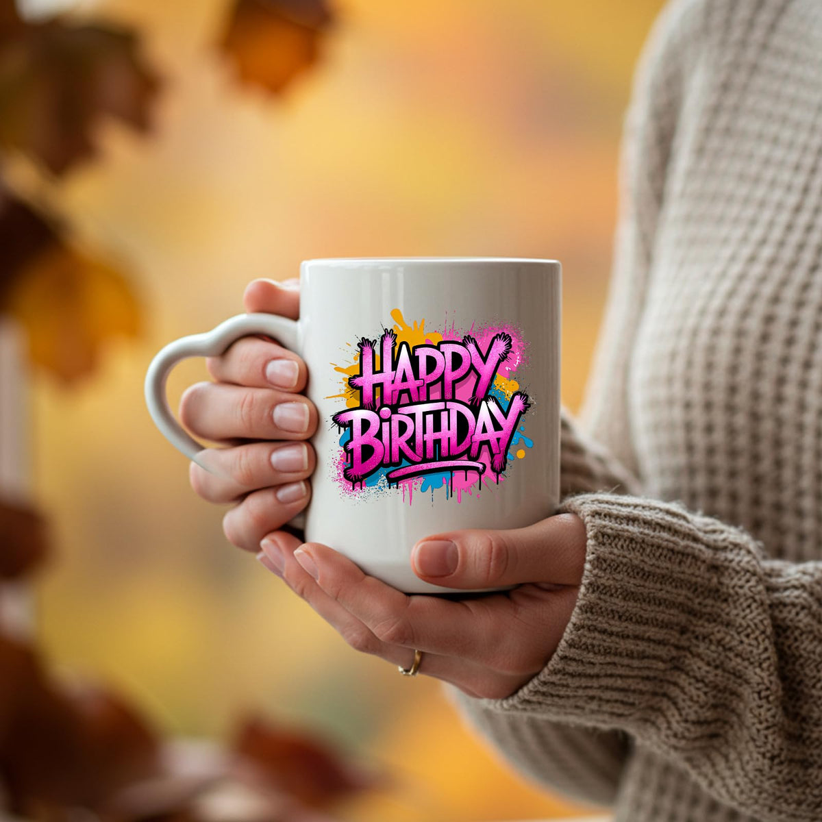 Hands holding the Happy Birthday pink graffiti splash heart-handle mug