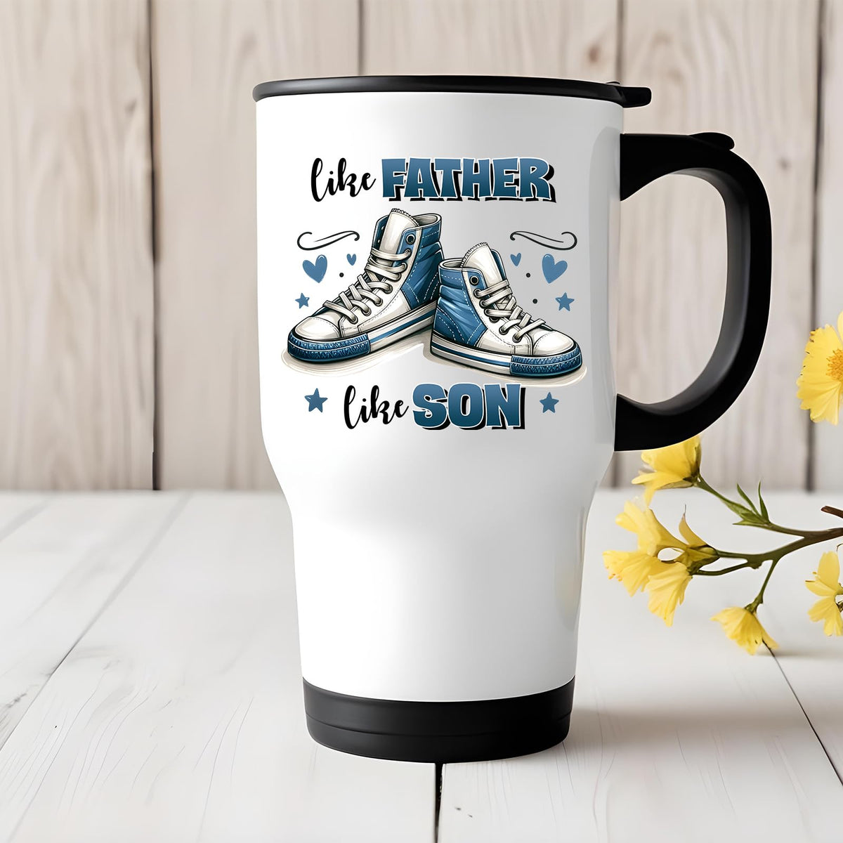 Like Father Like Son travel mug on a white wooden table with yellow flowers