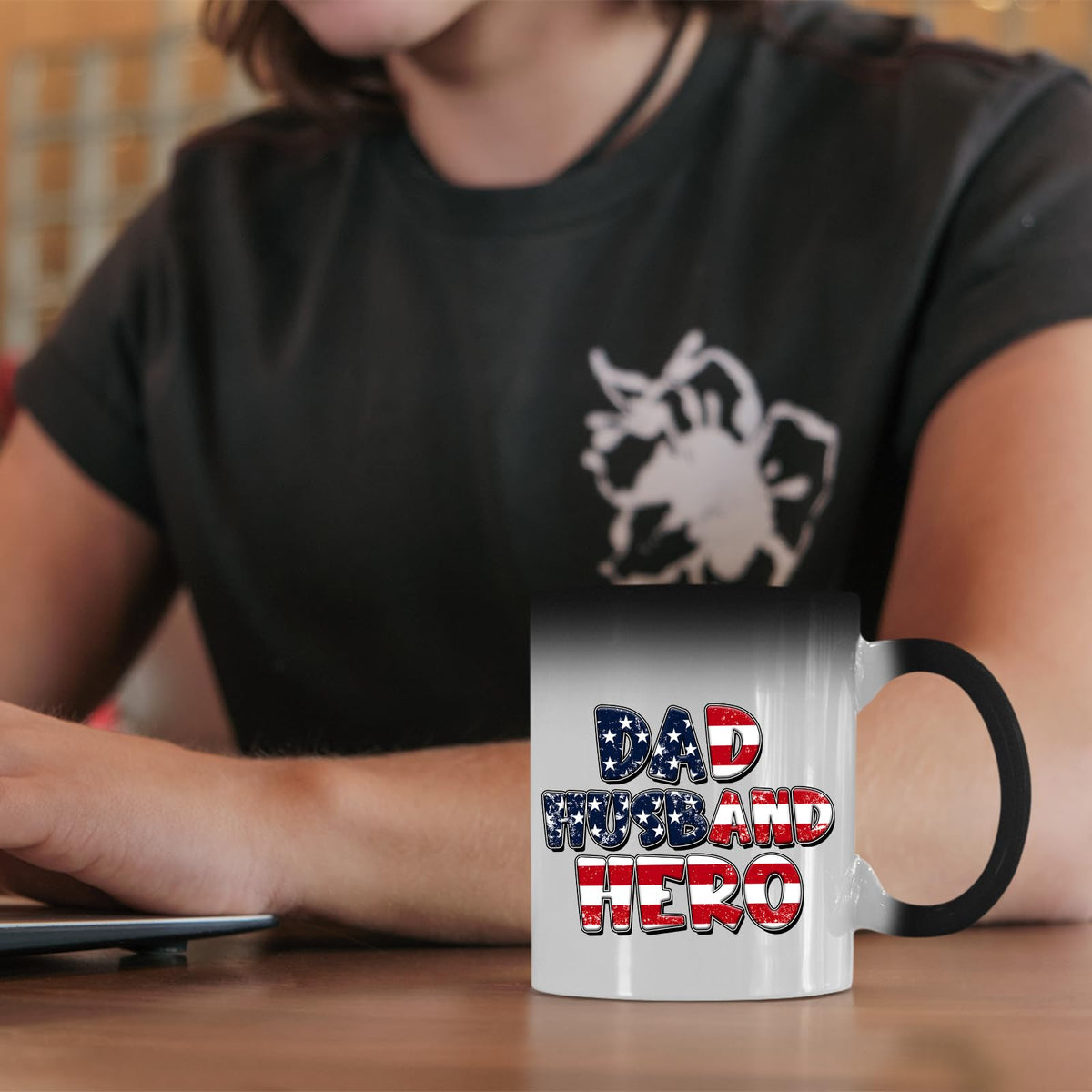 Dad Husband Hero colour changing mug on a desk beside a laptop