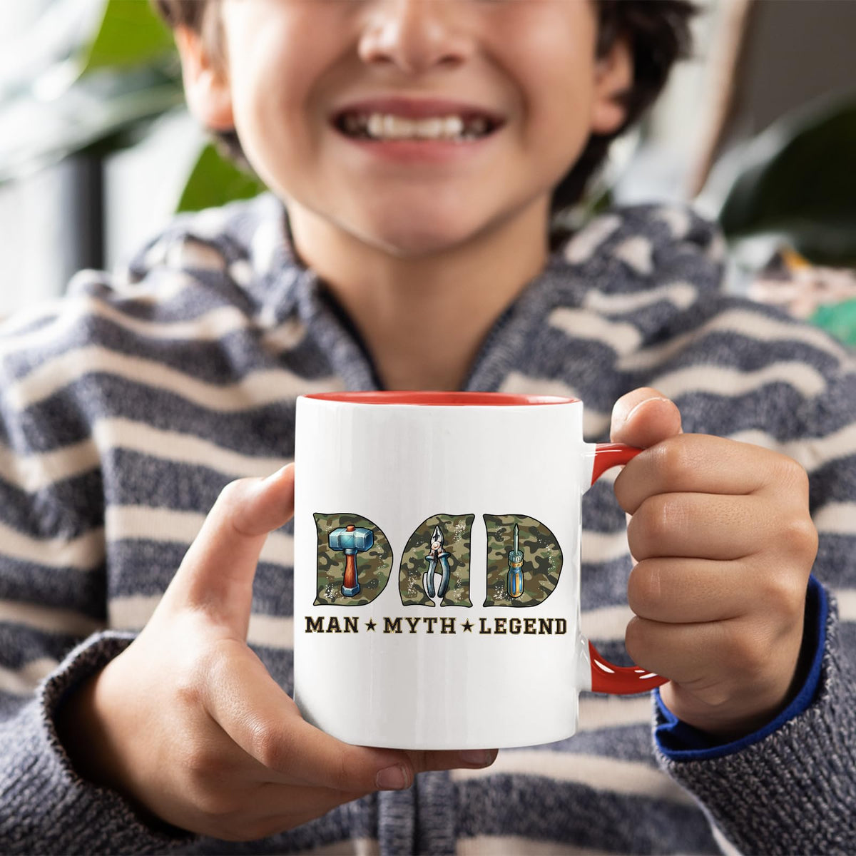 Smiling child holding the Dad Man Myth Legend tools mug with a red handle