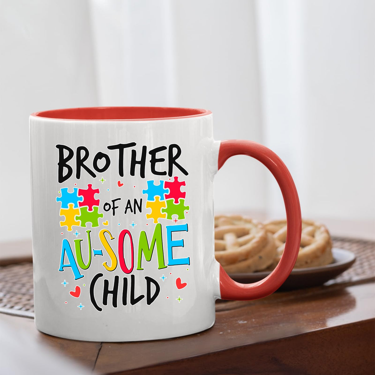 Brother of an Au-Some Child mug with a red handle beside biscuits