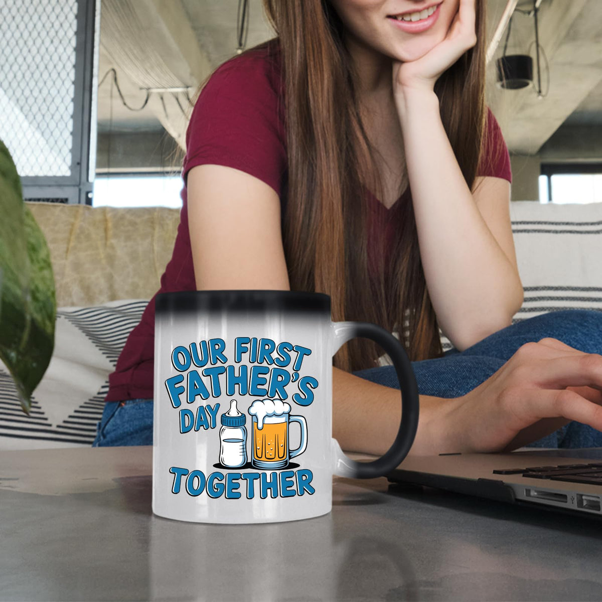 Woman at a laptop with the First Father’s Day bottle and beer colour changing mug
