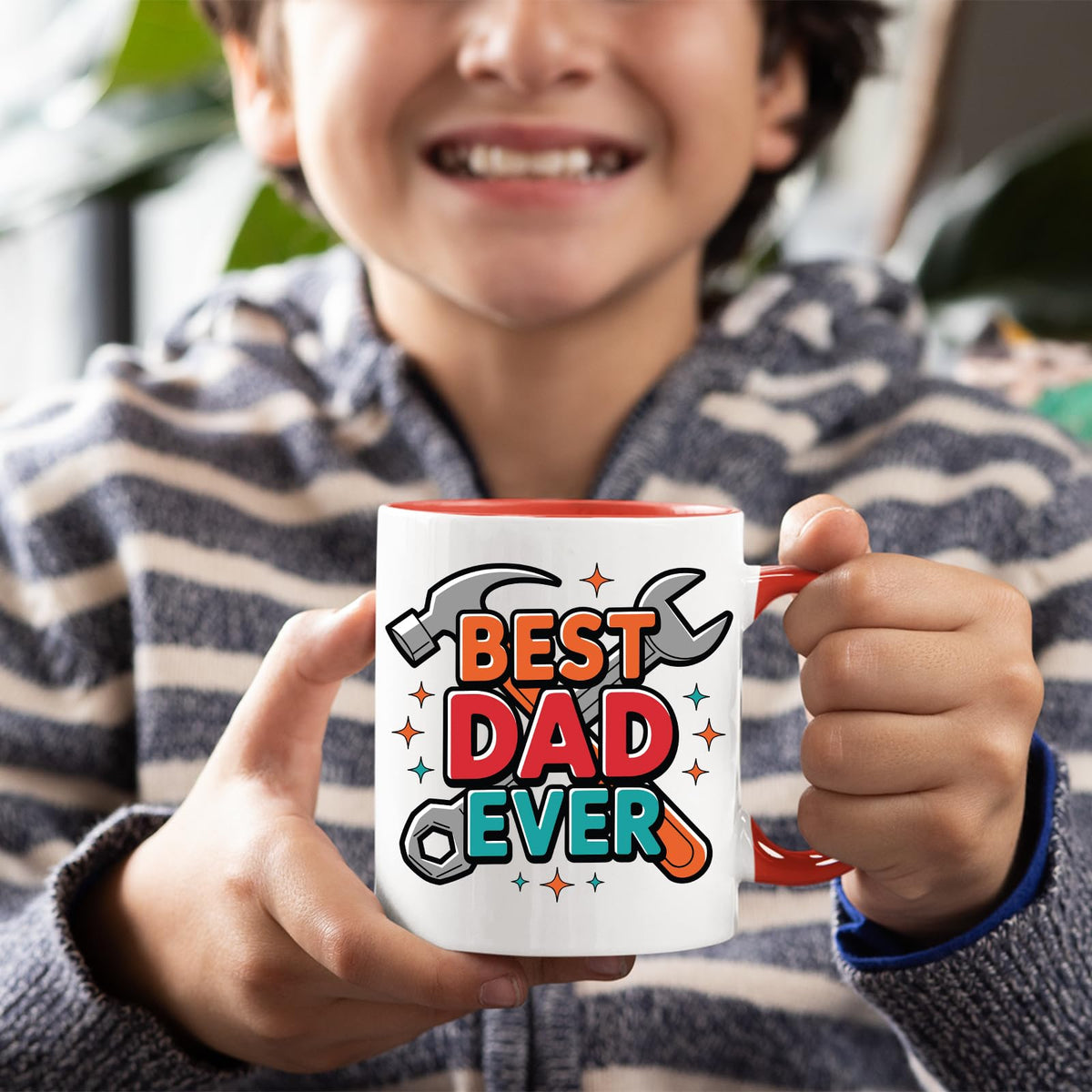 Smiling child holding the Best Dad Ever tools mug with a red handle