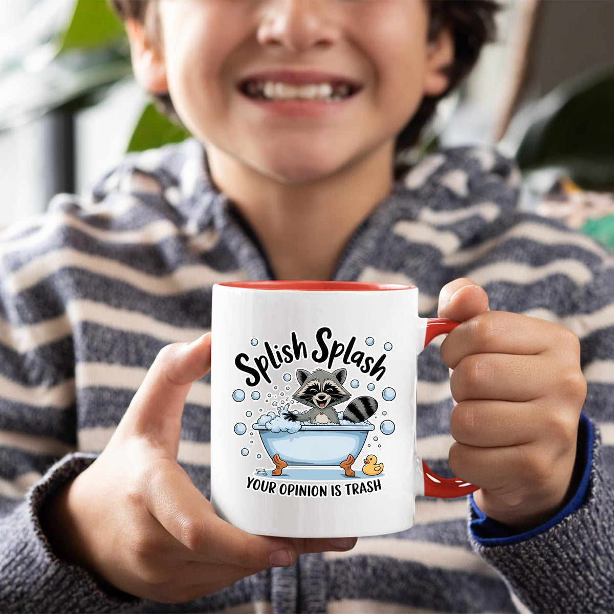 Smiling child holding the Splish Splash raccoon mug with a red handle