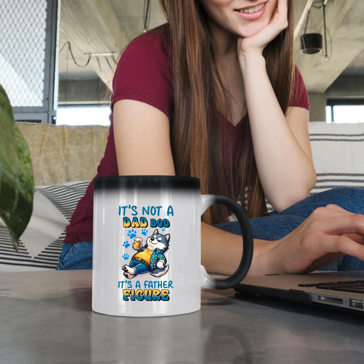 Woman at a laptop with the Dad Bod husky colour changing mug