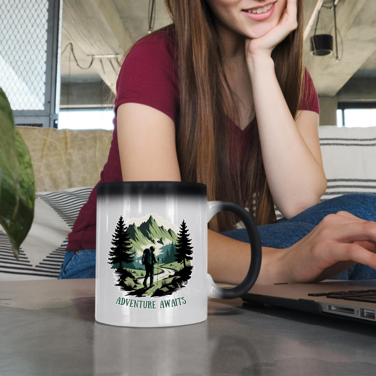 Woman at a laptop with the Adventure Awaits hiker colour changing mug