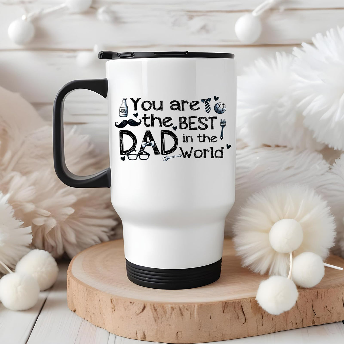 Best Dad in the World sketch travel mug on a wooden slice with white pom-poms